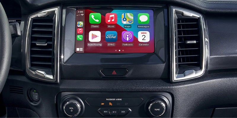 Lower center console showing electronic gear selector and cup holder