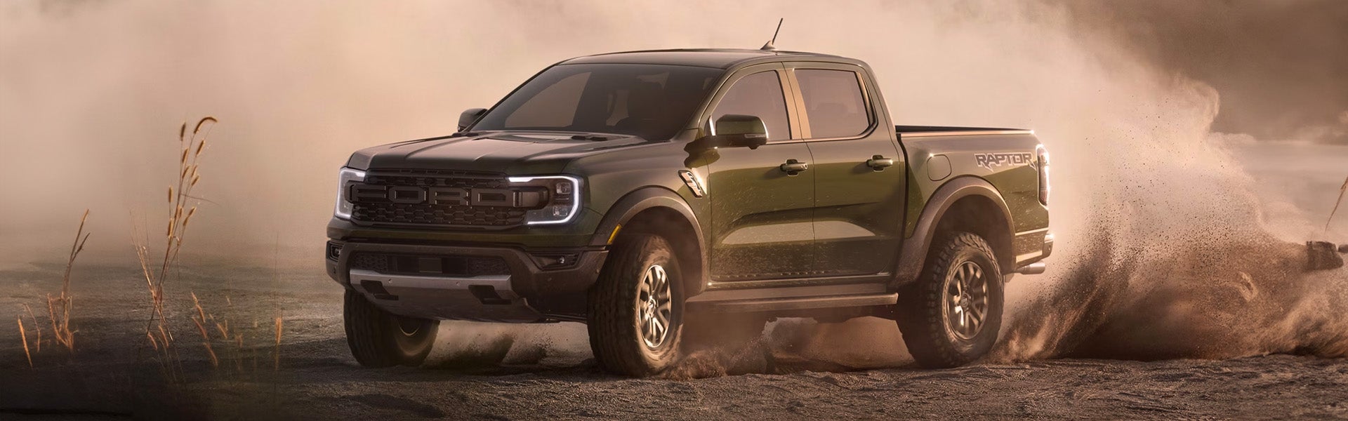 2024 Ford Ranger kicking up dust while off-roading in rugged terrai
