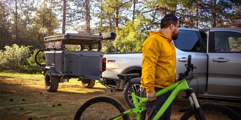 Ranger parked at a trailhead with bikes and gear being unloaded