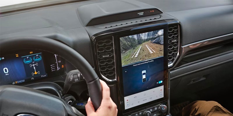 Driver operating the center touchscreen display in the Ford Range