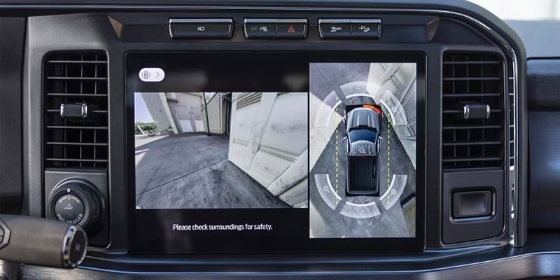 Infotainment screen showing top-down 360-degree camera view for parking assist
