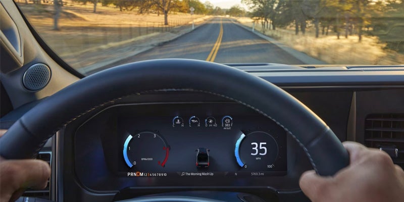 Steering wheel close-up while driving, showing digital speedometer