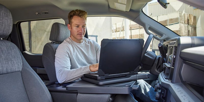 Man working on a laptop in the spacious front seat area