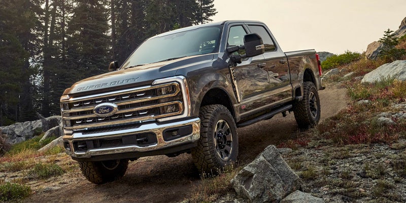 Super Duty driving uphill through a rugged off-road terrain