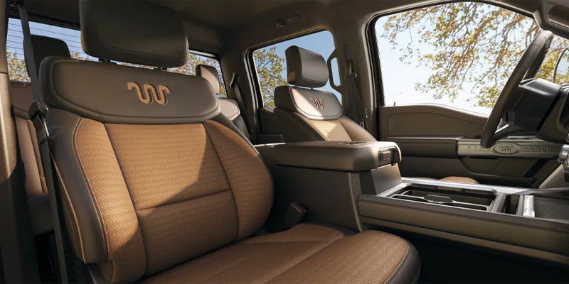 Luxurious brown leather interior seats with Western-themed stitching